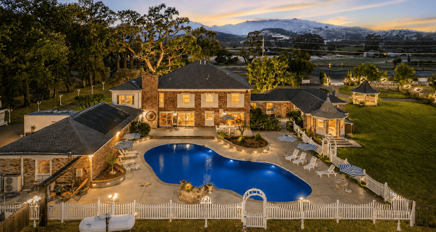 6a4ebac61c726_home page lux lodging backyard aerial at dusk